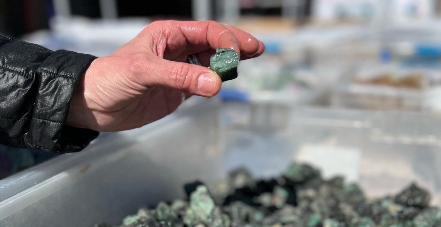 Karin pulling a stone from a bin